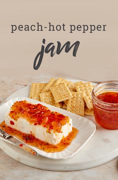 a white plate topped with cheese covered food next to crackers and ketchup