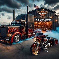 a large semi truck parked next to a motorcycle in front of a building with an american flag on it