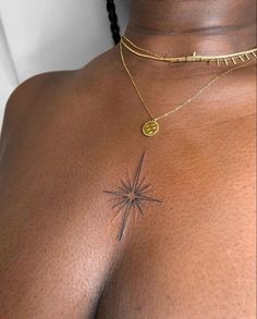 a woman's chest with a small star tattoo on the top of her chest