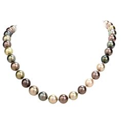 This very high quality lustrous South Sea peacock pearl and diamond strand necklace, weighs 80 grams and measures 19 inches long. Composed of 39 various colored creme to dark grey high quality AAA South Sea peacock pearls, ranging from 12mm - 10mm in diameter. Accented by one round 18k gold diamond pave set clasp set with round cut diamonds, weighing approximately, 1.65 carats, graded H-I color and VS and few SI clarity. Secures with a well concealed tongue in groove clasp. Remains in excellent South Sea Pearl Necklace, Pinterest Jewelry, Peacock Pearls, Tahitian Pearl Necklace, Heart Choker Necklace, Peacock Pearl, Beautiful Pearl Necklace, Golden South Sea Pearls, Pearl Chain Necklace