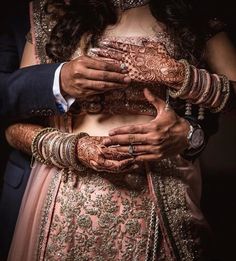 the bride and groom are holding each other's hands