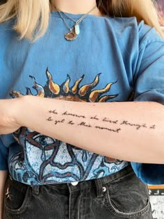 a woman with a tattoo on her arm that says, the sun is not shining