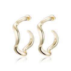 The Wave Hoop Earrings are a modern minimalist jewellery design with a fluid form for effortless styling. Also available in huggie size for layering, or as a smaller everyday hoop. Wear it with other styles from our core collection. DETAILS: High micron, ethically sourced 18K gold plating certified by LBMA Responsible Gold to meet international ethics standards. Eco Brass with 18K gold plating or 925 solid sterling silver. Nickel free 6 months warranty. Sold as a pair for pierced ears. Packaged Modern Yellow Gold Wrap Earrings, Fluid Shapes, Minimalist Jewellery, F H, Black Gift Boxes, Large Hoop Earrings, Single Earring, The Wave, Jewellery Design