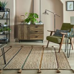 a living room filled with furniture and a rug on top of a hard wood floor