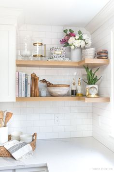 a kitchen with white cabinets and open shelves