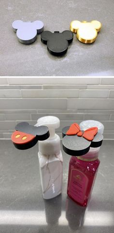 mickey mouse soap and lotion bottles sitting on a counter top next to each other