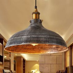 an industrial style pendant light hanging over a kitchen island