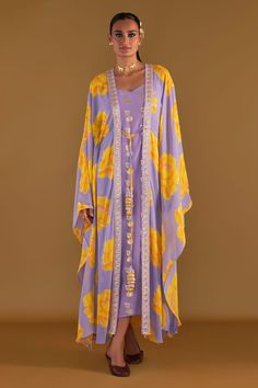 Lilac sunshine mimosas printed cover-up kaftan with tie-up tassel detail and embellished with border. Comes with all-over foil printed slip. - Aza Fashions Spring Kaftan With Tassels And Kimono Sleeves, Yellow Bohemian Sets For The Beach, Bohemian Yellow Sets For Beach, Bohemian Yellow Sets For The Beach, Bohemian Yellow Beach Sets, Bohemian Beach Tunic Set, Bohemian Tunic Beach Set, Summer Beach Silk Set, Purple Kaftan