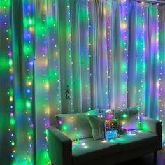 a living room filled with lots of lights next to a window covered in sheer curtains