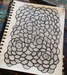 an art journal with spirals drawn on it