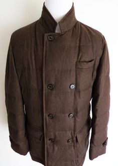 BRAND:  Brunello Cucinelli SIZE:  Marked as XL COLOR:  Dark Brown MATERIAL:  Shell: 89% Wool 5% Cashmere 6% Silk Lining: 100% Nylon Filling: Goose Down  ORIGINAL PRICE:  $4,370 FEATURES: - stay warm in this luxurious Brunello Cucinelli padded puffer coat - finished in soft high quality blend of fabrics - filled with premium goose feather and lined with nylon - stylish two way front zip closure - also has additional button front closure with signature Brunello buttons - stand up collar - two snap button closure hand pockets and one chest pocket - two button closure and two zip closure inside pockets - dual vent on the back with snap button closure - made in Italy - $4,370 price tag attached MEASUREMENTS: Shoulders: 20 inches Chest: 24.5 inches Sleeves: 27 inches Length (from bottom of Colla Affordable Brown Bottoms For Winter, Luxury Stand Collar Tops For Men, Goose Feather, Cashmere Jacket, Blue Winter, Goose Feathers, Stand Up Collar, Loro Piana, Puffer Coat