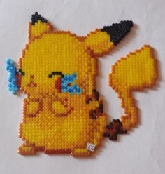 a piece of beaded art depicting pikachu