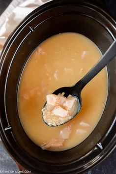 a spoon full of soup in a crock pot