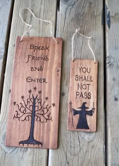 two wooden tags with words on them that say, you shall not pass and an image of a wizard holding a staff