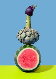 a watermelon and an onion on top of each other with a blue sky in the background