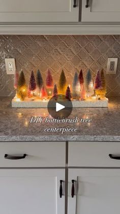 a kitchen counter with christmas lights on it and the words diy bath tree centerpiece