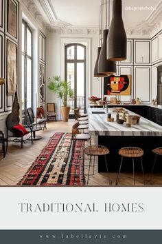 the interior of a large kitchen with white cabinets and black counter tops is featured in an article about traditional homes