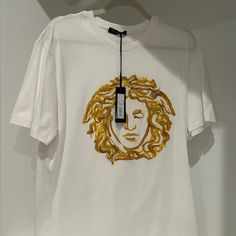 Brand New Versace Top W/ Beautiful Print. Luxury White Tops With Embroidered Logo, Luxury Gold Tops With Graphic Print, Luxury Gold Top With Graphic Print, Versace Slides, Versace Polo, Luxury Men's T-shirt With Exclusive Print, Versace Mens Shirt, Versace Top, Versace Tshirt Men