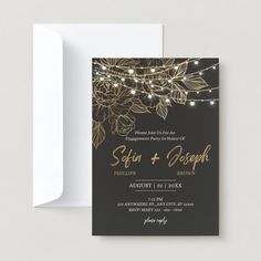 a black and gold wedding card with string lights