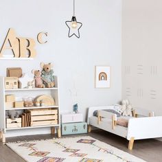 a child's bedroom with white walls and furniture