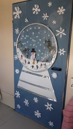 a door decorated with snowflakes and a snowman in a hat on top