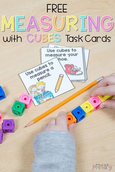 a child is holding a pencil and measuring cubes with the words measurement on them