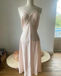 How delicate is this pastel pink dress, a 1940s slip, in the softest silk ?  Entirely sewn by hand, it falls beautifully to enhance the body. There are embroideries of four flowers at the bust.  Decorative seams embellish the bust and upper waist. The neck has scalloped hems.  This 1940s slip is a small size. Measurements are 90cm bust for a 72cm waist.  Length is 87cm from armpit to bottom end. The straps length are 38cm in total. It is in excellent condition. There is only a very small dot/sta 1940s Slip, Pastel Pink Dress, Decorative Seams, Vintage Slip Dress, Vintage Slip, Vintage Slips, Rose Pastel, Pink Pastel, Silk Slip