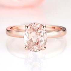 Gorgeous minimalist solitaire morganite ring made of 14k rose gold over 925 solid sterling silver, making a simple but elegant statement piece. Center Stone: MorganiteStone Creation: Lab-CreatedColor: Peachy-PinkShape: OvalGem size: 7.0 x 9.0 mmCarat Weight: 2 ct. (approx.)✓ Comfort Fit✓ Free Ring Box✓ Free USA Shipping✓ Ready to ship next business day Dainty Promise Rings, Oval Morganite Ring, Engagement Ring Dainty, Popular Engagement Rings, Engagement Ring Sizes, Morganite Ring, Creating Jewelry, Wedding Ring Designs, Solid Gold Jewelry