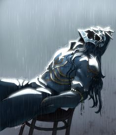 a woman sitting on top of a chair in the rain