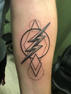 a black and white photo of a man's leg with a lightning tattoo on it