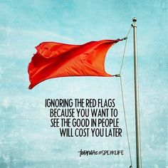 a red flag flying high in the sky with a quote from pope benedict on it