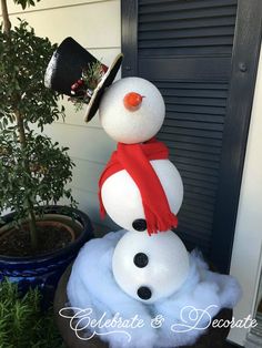 a snowman with a hat and scarf on top of it