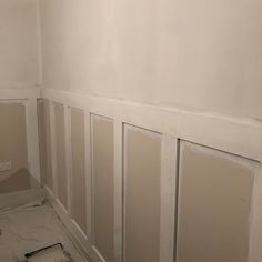 an empty room with white paint on the walls