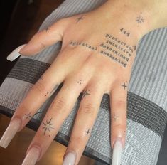 a woman's hand with tattoos on it and the words written in cursive writing