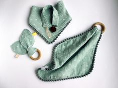 two green cloths with wooden handles on them