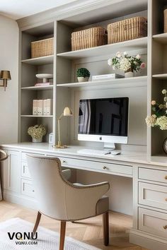 a desk with a computer on top of it in front of a white bookcase