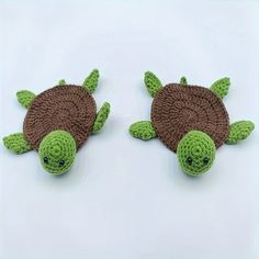 two crocheted sea turtles sitting next to each other