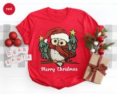 an owl wearing a santa hat and holding a christmas tree