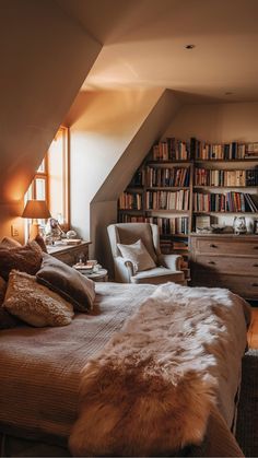 Cozy bedroom with a large bed, plush blankets, a reading chair, and a bookshelf filled with books. Cozy Bedroom Books, Hygge Bedroom Aesthetic, Tiny Cozy Bedroom, Virgo Bedroom, Big Cozy Bedroom, Home Cozy Aesthetic, Cozy Warm Bedroom, Cozy Winter Bedroom, Books In Bed