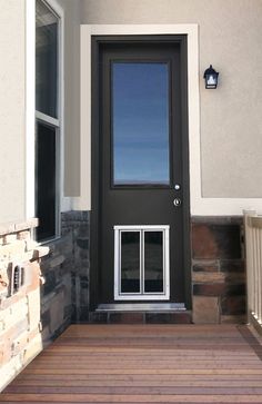 a black front door with a glass pane