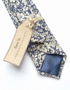 DESCRIPTION: This lovely men's skinny tie has been handmade using a lovely navy blue ditzy floral cotton.FABRIC: Cotton.LINING FABRIC: Silk.--------------------------------------------------------------------------------------------DETAILS:• Made the traditional way with fabric cut on the bias• Each tie has canvas lining throughout• Fabric lining just at the tip on each end of the tie• Width at the widest part measures approx 2.5 inches• The length of each tie is approx 58 Inches• Comes packaged Mens Floral Tie, Wedding Tie, Tie Men's, Wedding Ties, Handmade Bows, Men Fits, Fabric Silk, Navy Floral, Lining Fabric