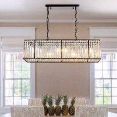 a chandelier hanging over a dining room table