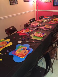 a long table with plates and decorations on it