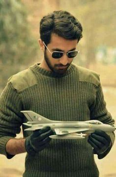 a man holding a model airplane in his hands