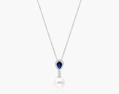 14K White Gold Akoya Cultured Pearl and Sapphire Drop Necklace (9.5mm). Feel glamorous with this stunning 14K white gold drop pendant displaying a deep blue pear shape sapphire with a diamond halo and an Akoya pearl for a soft and elegant look. Pendant measures 23mm in length and 9.5mm width. Formal Sapphire Pear-shaped Necklaces, Formal Pear-shaped Sapphire Necklace, Akoya Pearls, Diamond Halo, Drop Necklace, Drop Pendant, Cultured Pearls, Pear Shape, Halo Diamond