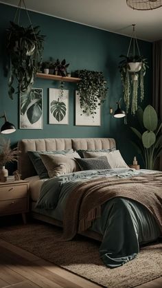 a bedroom with green walls and plants hanging on the wall above the bed, along with two nightstands