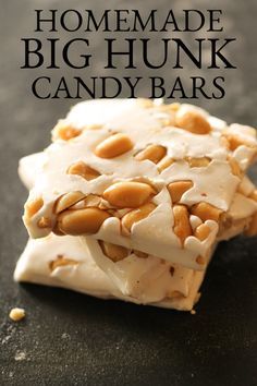 homemade big hunk candy bars with white frosting and almonds on top, sitting on a black surface