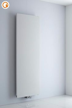 a white radiator mounted to the side of a wall in an empty room