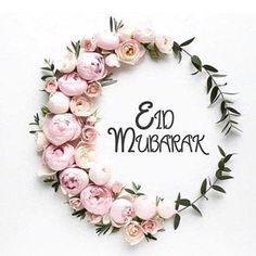 the words eid mubaran are surrounded by pink flowers and greenery on a white background