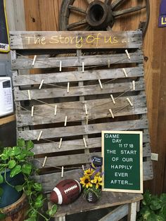 a wooden sign that says the story of us with flowers and footballs on it